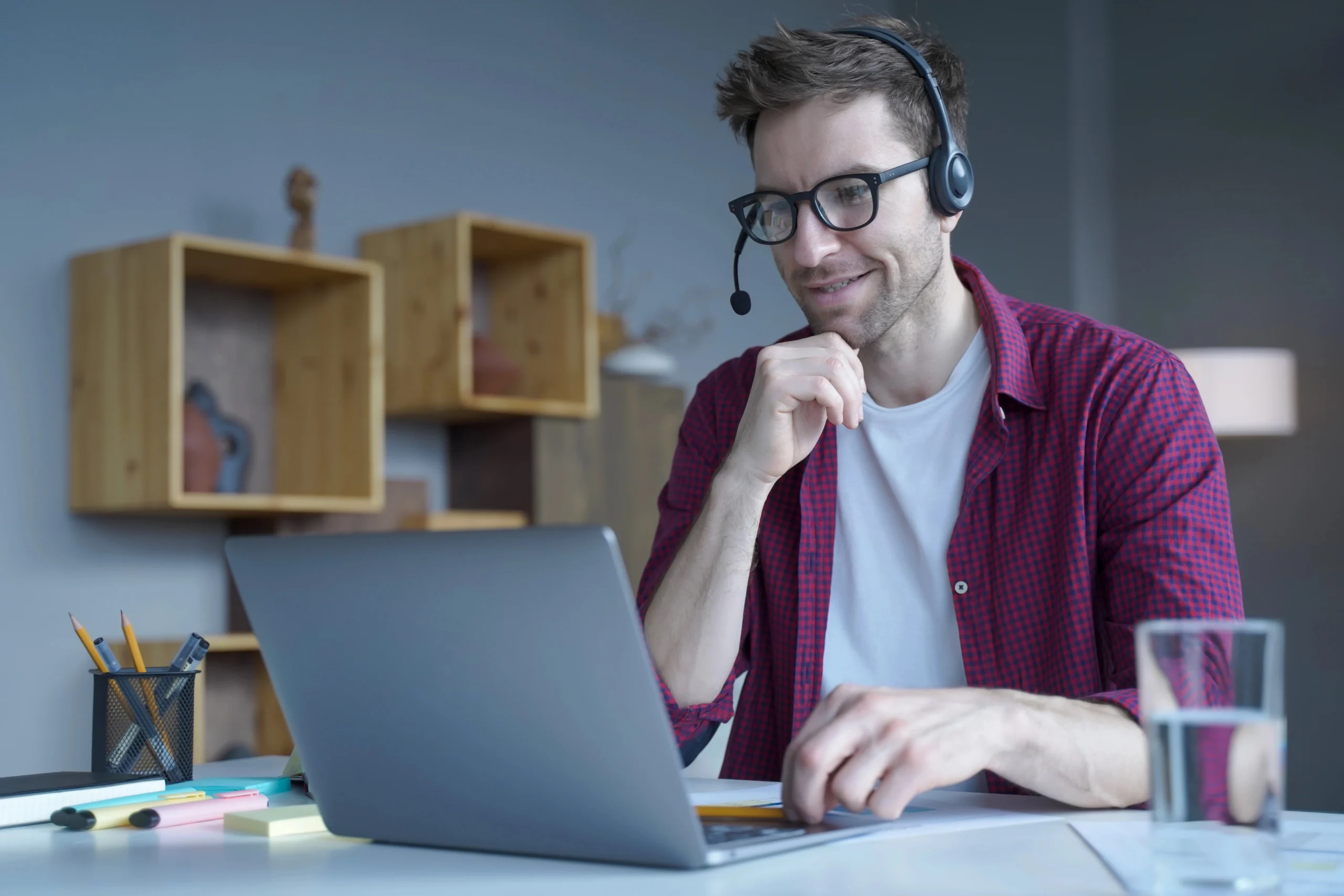smiling-guy-sitting-at-home-in-wireless-hea-2022-01-04-23-33-11-utc-copy